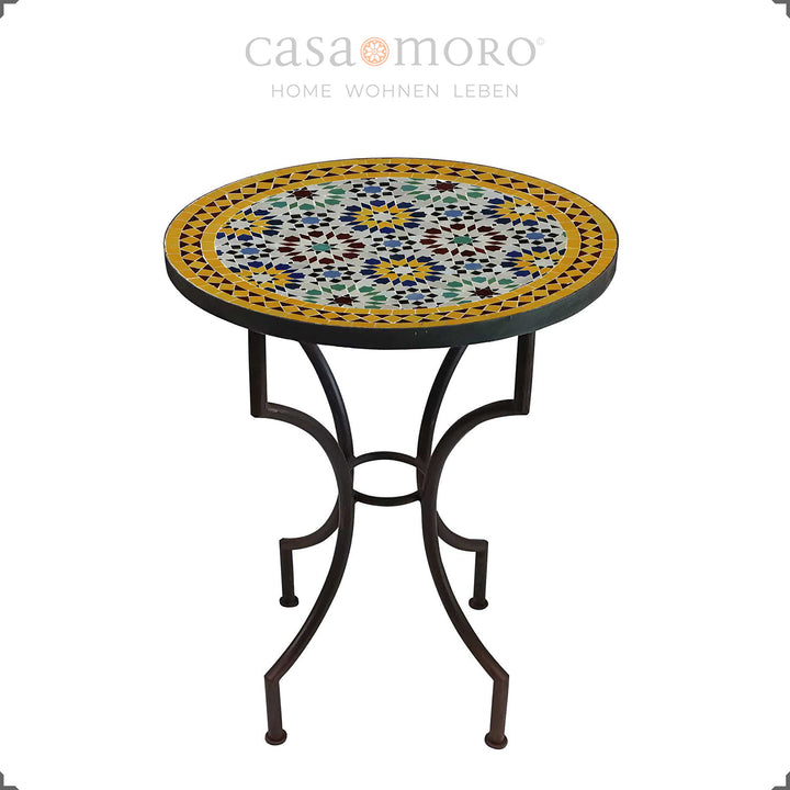 Table de jardin avec un motif mosaïque intense en bleu, jaune, bordeaux et vert - table ronde pour deux personnes