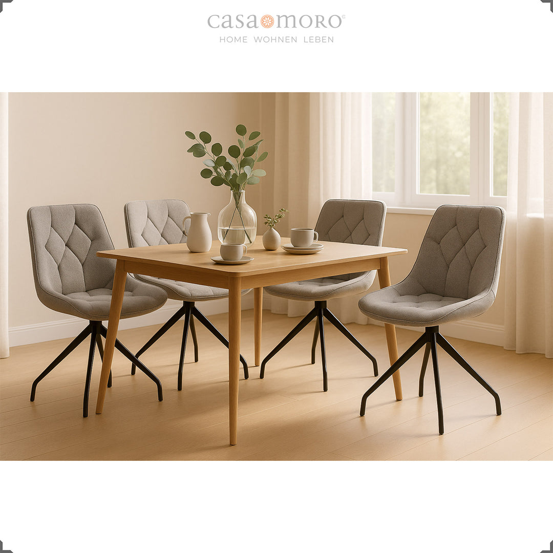 Quatre chaises de salle à manger grises avec fonction pivotante à 360° et structure en métal noir - coin repas lumineux avec table en bois et décoration naturelle