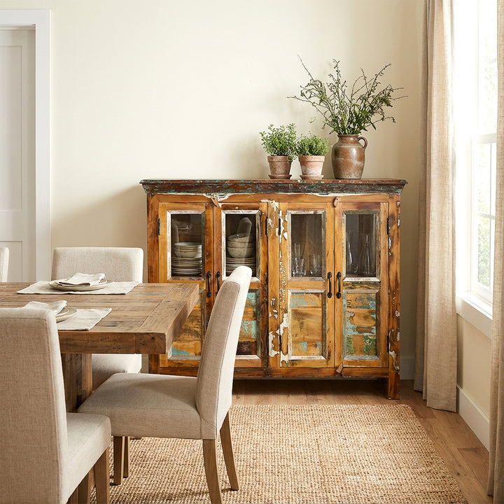 Massief houten dressoir met glazen deuren in de eetkamer als opbergruimte voor borden en glazen