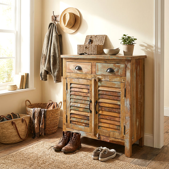 Buffet en bois massif dans le couloir avec paniers et chaussures, ambiance chaleureuse maison de campagne
